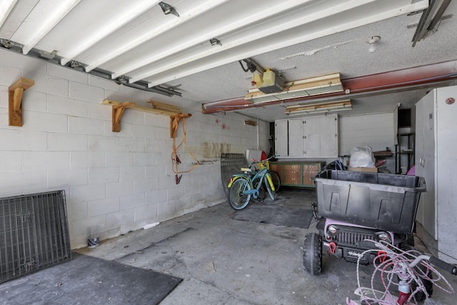 11620 Highland Park, Logan, OH 43138 - garage featuring a garage door opener and concrete block wall