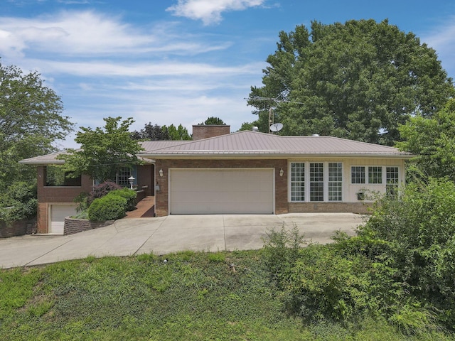 11620 Highland Park, Logan, OH 43138 - ranch-style home with driveway, brick siding, a metal roof, and an attached garage