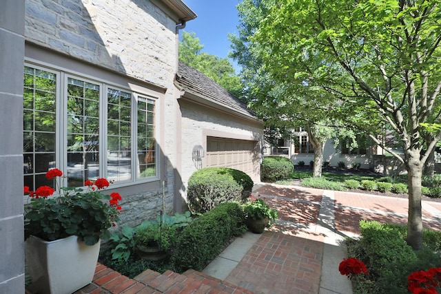 5720 Loch Maree Ct, Dublin, OH 43017 - view of side of property with an attached garage, stucco siding, and driveway