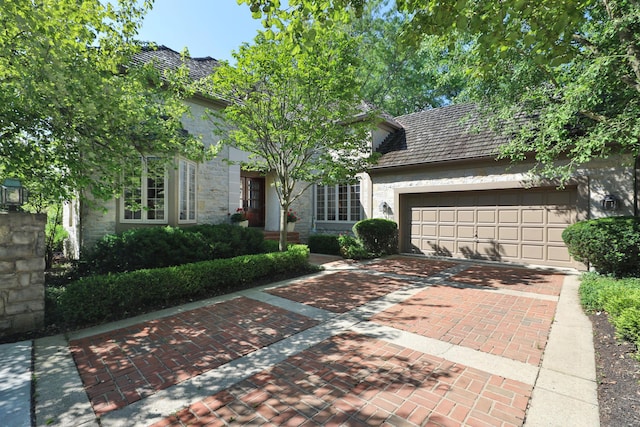 5720 Loch Maree Ct, Dublin, OH 43017 - view of front of property featuring decorative driveway, an attached garage, and stone siding