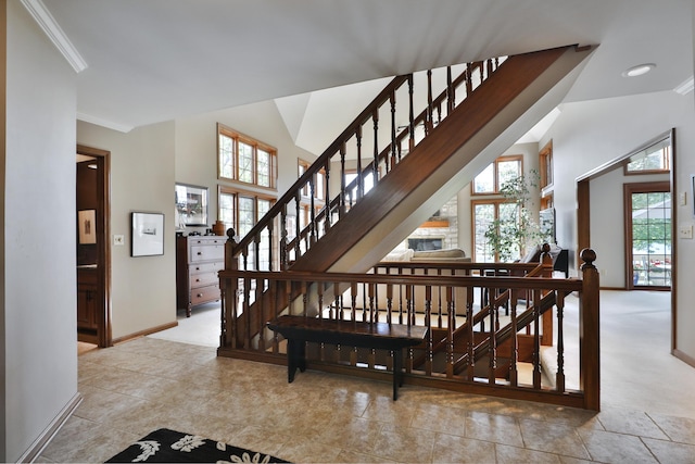 5720 Loch Maree Ct, Dublin, OH 43017 - staircase featuring plenty of natural light, crown molding, and vaulted ceiling