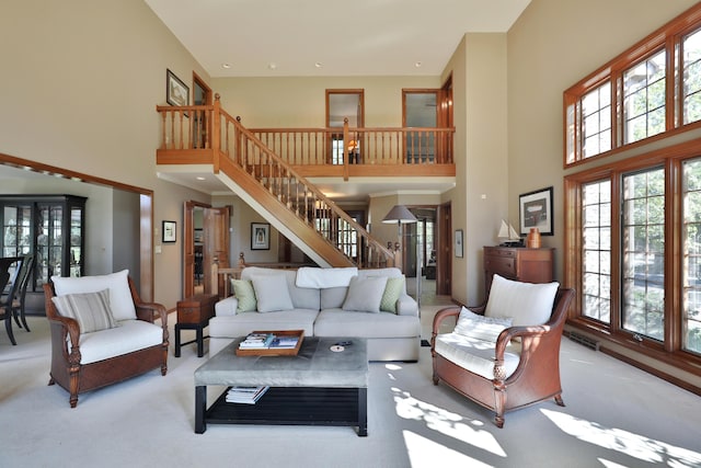5720 Loch Maree Ct, Dublin, OH 43017 - carpeted living room with a high ceiling, stairs, and plenty of natural light