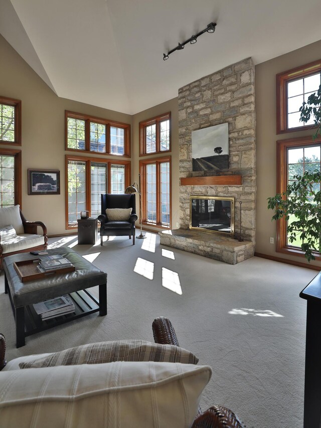 5720 Loch Maree Ct, Dublin, OH 43017 - living room with carpet flooring, track lighting, high vaulted ceiling, and a stone fireplace