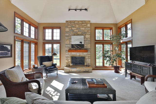 5720 Loch Maree Ct, Dublin, OH 43017 - carpeted living area featuring plenty of natural light, high vaulted ceiling, a stone fireplace, and track lighting