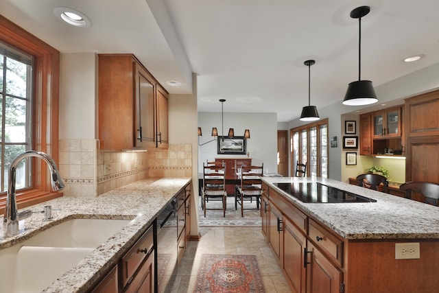 5720 Loch Maree Ct, Dublin, OH 43017 - kitchen with black electric cooktop, dishwashing machine, brown cabinetry, healthy amount of natural light, and recessed lighting