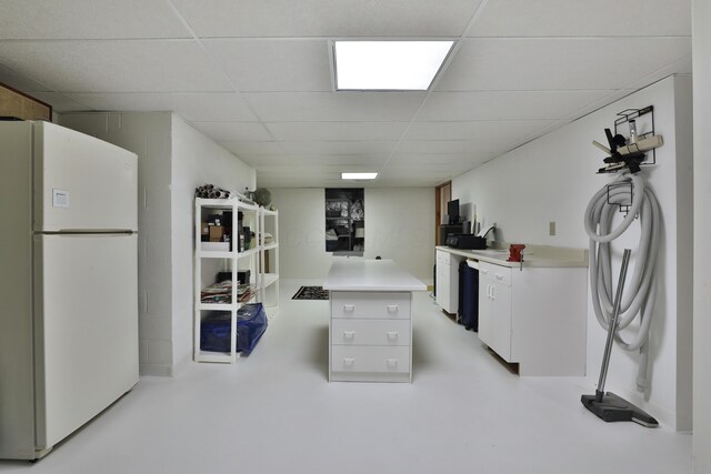 5720 Loch Maree Ct, Dublin, OH 43017 - kitchen with freestanding refrigerator, a paneled ceiling, light countertops, white cabinets, and finished concrete floors