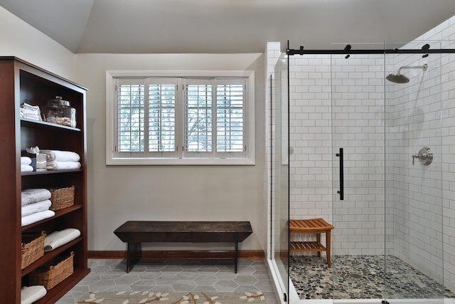 5720 Loch Maree Ct, Dublin, OH 43017 - bathroom featuring a shower stall, tile patterned flooring, and lofted ceiling