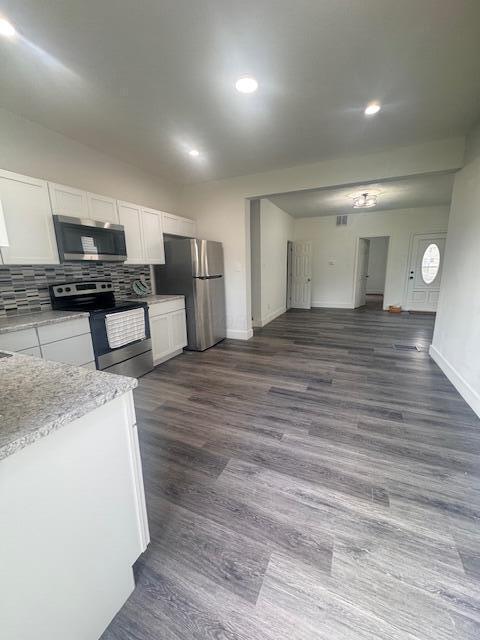 689 Reinhard Ave, Columbus, OH 43206 - kitchen with stainless steel appliances, white cabinets, dark wood-style floors, tasteful backsplash, and recessed lighting