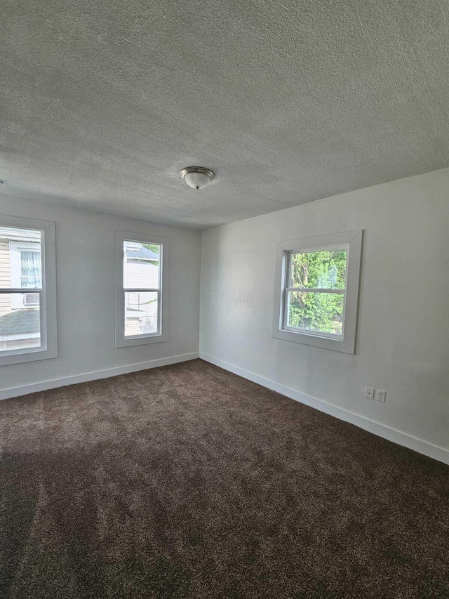 689 Reinhard Ave, Columbus, OH 43206 - unfurnished room with dark carpet and a textured ceiling