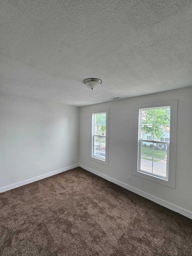 689 Reinhard Ave, Columbus, OH 43206 - spare room with dark carpet and a textured ceiling