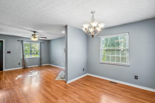 4905 Mckenna Ct, Columbus, OH 43221 - unfurnished room with wood finished floors, a chandelier, ceiling fan, and a textured ceiling