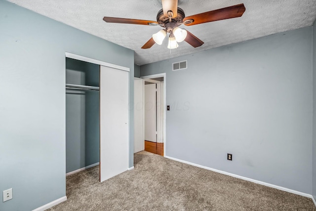 4905 Mckenna Ct, Columbus, OH 43221 - unfurnished bedroom featuring a textured ceiling, carpet floors, a closet, and a ceiling fan