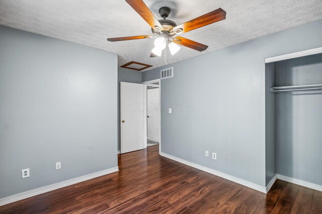 4905 Mckenna Ct, Columbus, OH 43221 - unfurnished bedroom featuring wood finished floors, a closet, a textured ceiling, ceiling fan, and attic access