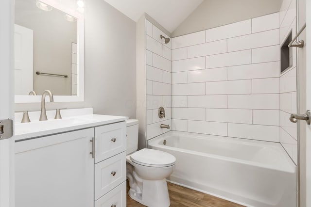 310 S Ogden Ave, Columbus, OH 43204 - bathroom with wood finished floors, vanity, bathtub / shower combination, and lofted ceiling