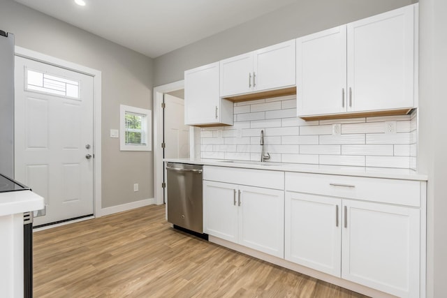 310 S Ogden Ave, Columbus, OH 43204 - kitchen featuring stainless steel dishwasher, light countertops, light wood-style floors, decorative backsplash, and recessed lighting