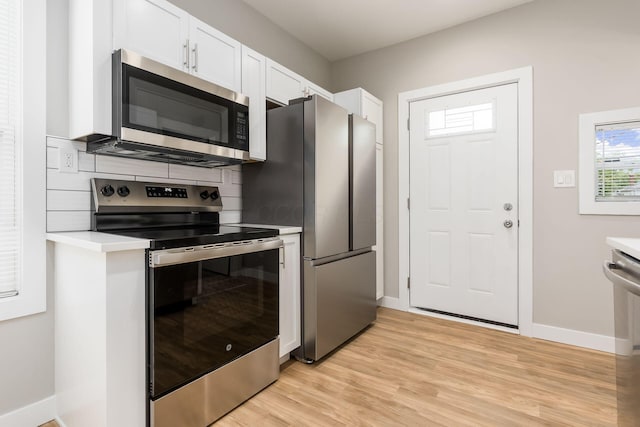 310 S Ogden Ave, Columbus, OH 43204 - kitchen featuring appliances with stainless steel finishes, white cabinets, light countertops, and light wood finished floors
