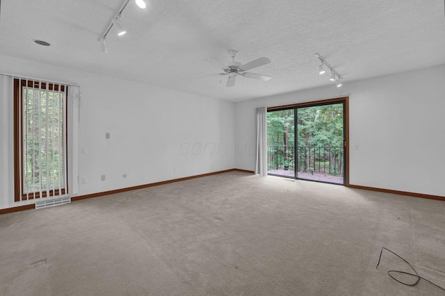 71 Denison Dr, Granville, OH 43023 - empty room featuring track lighting, ceiling fan, a textured ceiling, and carpet floors