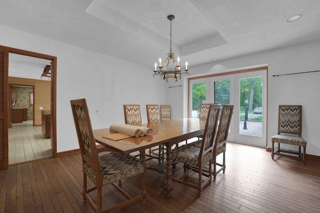 71 Denison Dr, Granville, OH 43023 - dining area featuring wood-type flooring, a textured ceiling, a chandelier, a raised ceiling, and recessed lighting