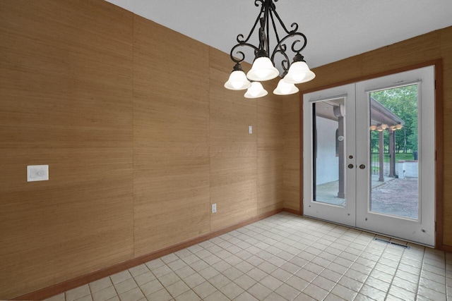 71 Denison Dr, Granville, OH 43023 - empty room featuring french doors, a chandelier, and light tile patterned floors