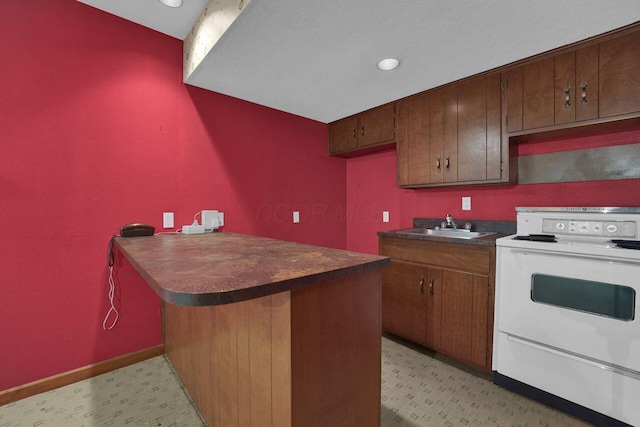 71 Denison Dr, Granville, OH 43023 - kitchen with white range with electric stovetop, dark countertops, a peninsula, light floors, and recessed lighting