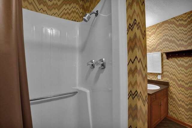 71 Denison Dr, Granville, OH 43023 - full bath with vanity, wallpapered walls, and a shower