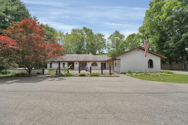 71 Denison Dr, Granville, OH 43023 - single story home with a fenced front yard, a chimney, and asphalt driveway