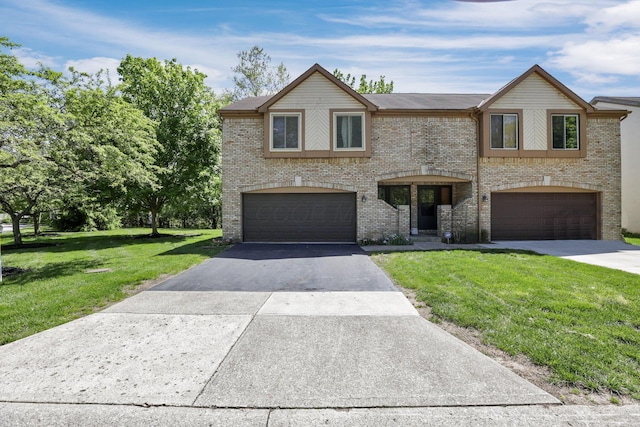 389 Fenway Rd Unit B, Columbus, OH 43214 - view of front facade with a garage, asphalt driveway, a front yard, and brick siding