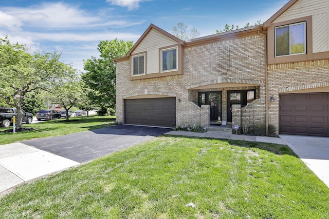 389 Fenway Rd Unit B, Columbus, OH 43214 - view of front of home with brick siding, an attached garage, a front lawn, and driveway