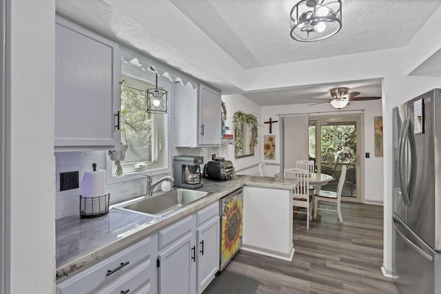 389 Fenway Rd Unit B, Columbus, OH 43214 - kitchen with stainless steel appliances, a textured ceiling, plenty of natural light, dark wood finished floors, and decorative backsplash