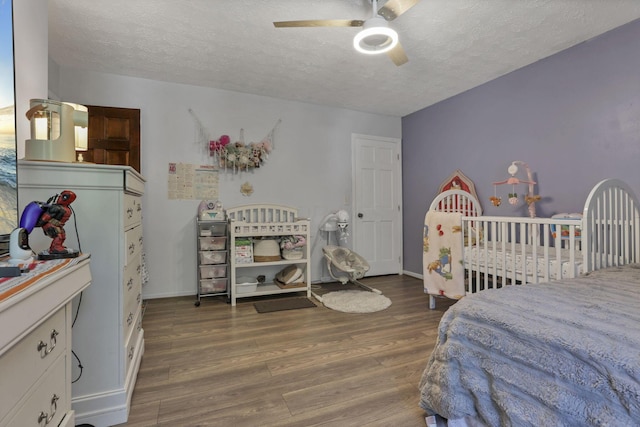 389 Fenway Rd Unit B, Columbus, OH 43214 - bedroom with a textured ceiling, wood finished floors, and a ceiling fan