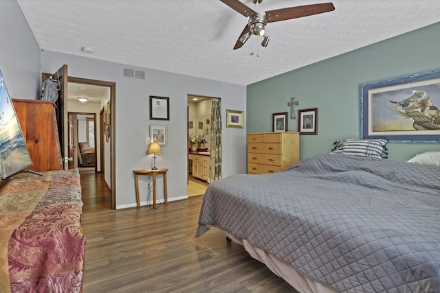 389 Fenway Rd Unit B, Columbus, OH 43214 - bedroom featuring wood finished floors, a textured ceiling, ceiling fan, and connected bathroom