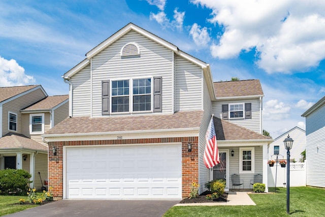 281 Inah Ave, Columbus, OH 43228 - traditional-style home with driveway, a garage, brick siding, and roof with shingles