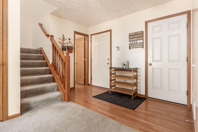 281 Inah Ave, Columbus, OH 43228 - foyer entrance featuring wood finished floors, stairway, and a textured ceiling