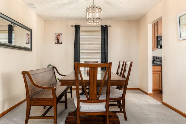 281 Inah Ave, Columbus, OH 43228 - dining room featuring light carpet, a chandelier, and a textured ceiling