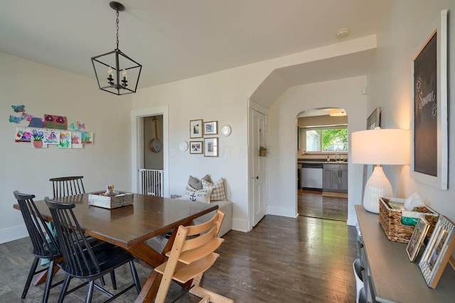 162 Watt St, Circleville, OH 43113 - dining space with arched walkways, dark wood-style flooring, and a chandelier