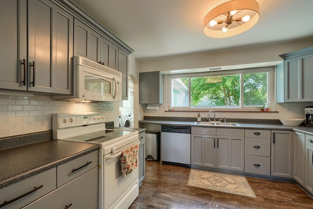 162 Watt St, Circleville, OH 43113 - kitchen featuring white appliances, gray cabinets, decorative backsplash, dark countertops, and dark wood finished floors