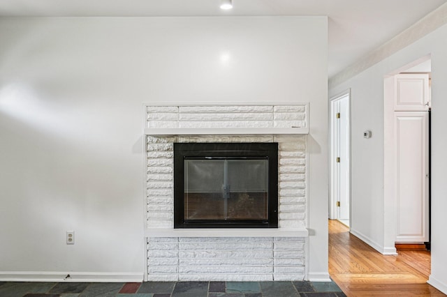 902 Brentford Dr, Columbus, OH 43220 - detailed view of baseboards and a brick fireplace