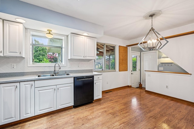 902 Brentford Dr, Columbus, OH 43220 - kitchen featuring black dishwasher, healthy amount of natural light, white cabinetry, and a chandelier