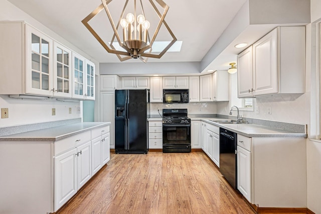 902 Brentford Dr, Columbus, OH 43220 - kitchen featuring black appliances, white cabinets, glass insert cabinets, and recessed lighting