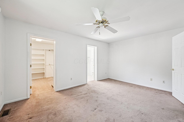 902 Brentford Dr, Columbus, OH 43220 - unfurnished bedroom with carpet, a spacious closet, a closet, a ceiling fan, and ensuite bath