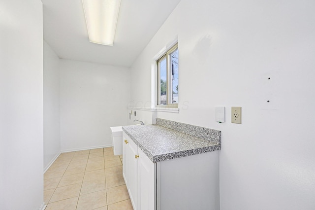 902 Brentford Dr, Columbus, OH 43220 - laundry room with light tile patterned flooring and baseboards