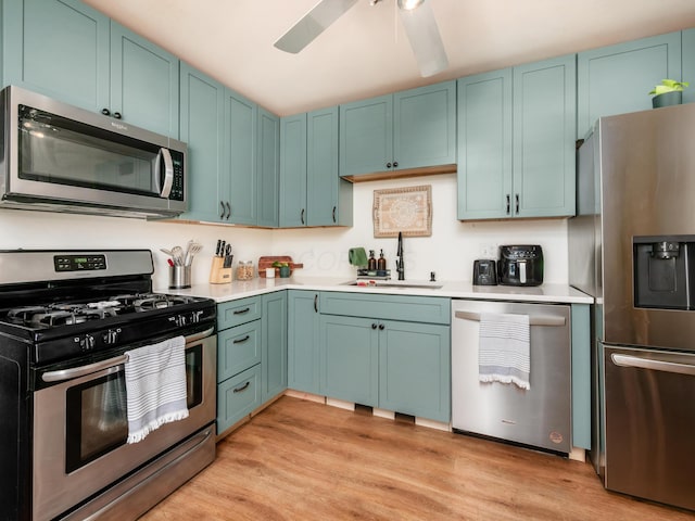 139 Cullman Rd, Columbus, OH 43207 - kitchen with appliances with stainless steel finishes, light countertops, light wood-style floors, and a ceiling fan