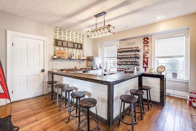 100 E Ohio Ave, Mount Vernon, OH 43050 - indoor dry bar with a textured ceiling, hardwood / wood-style flooring, and healthy amount of natural light