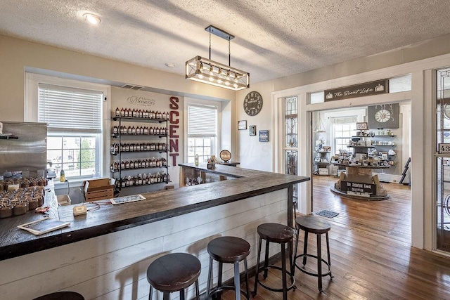 100 E Ohio Ave, Mount Vernon, OH 43050 - indoor dry bar featuring a textured ceiling, plenty of natural light, and wood finished floors