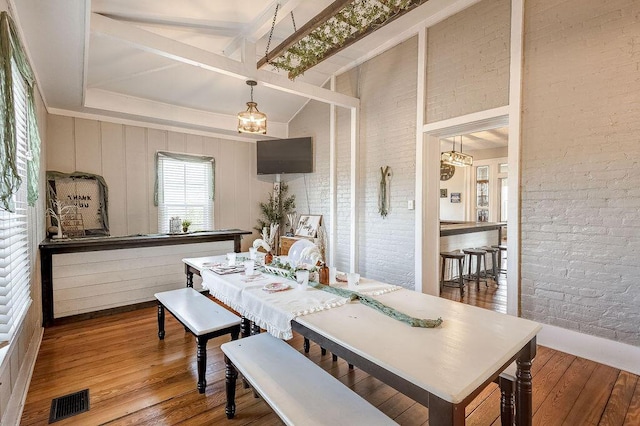 100 E Ohio Ave, Mount Vernon, OH 43050 - dining space with hardwood / wood-style flooring, a chandelier, and brick wall