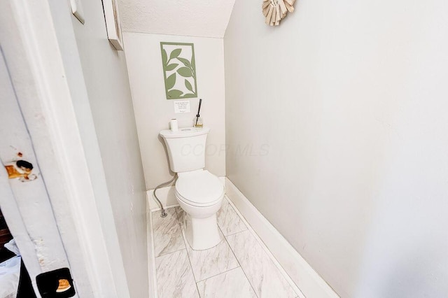 100 E Ohio Ave, Mount Vernon, OH 43050 - bathroom with marble look tiles and a textured ceiling