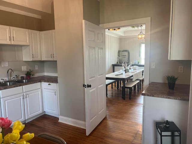100 E Ohio Ave, Mount Vernon, OH 43050 - kitchen with dark wood-style floors, dark countertops, and white cabinets