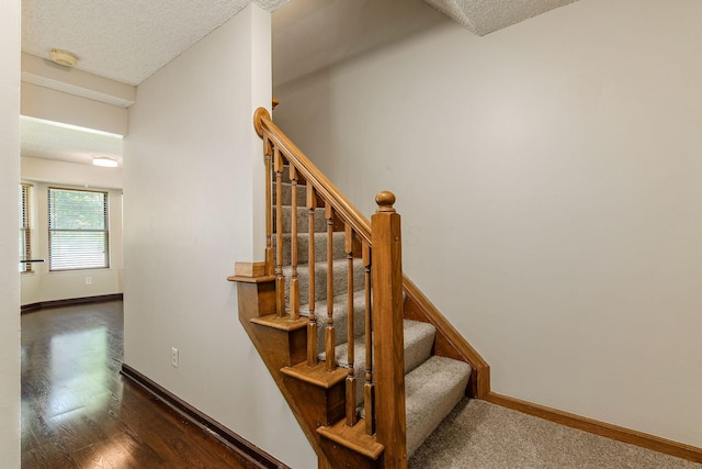 7345 Oakmeadows Dr, Columbus, OH 43085 - stairs with a textured ceiling and wood finished floors