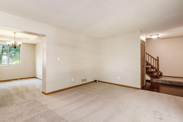 7345 Oakmeadows Dr, Columbus, OH 43085 - spare room featuring carpet, stairs, a chandelier, and a textured ceiling