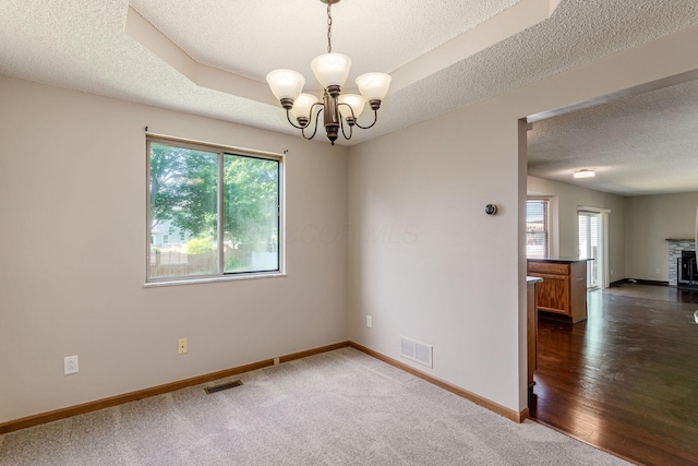 7345 Oakmeadows Dr, Columbus, OH 43085 - spare room featuring a textured ceiling, a chandelier, and dark carpet